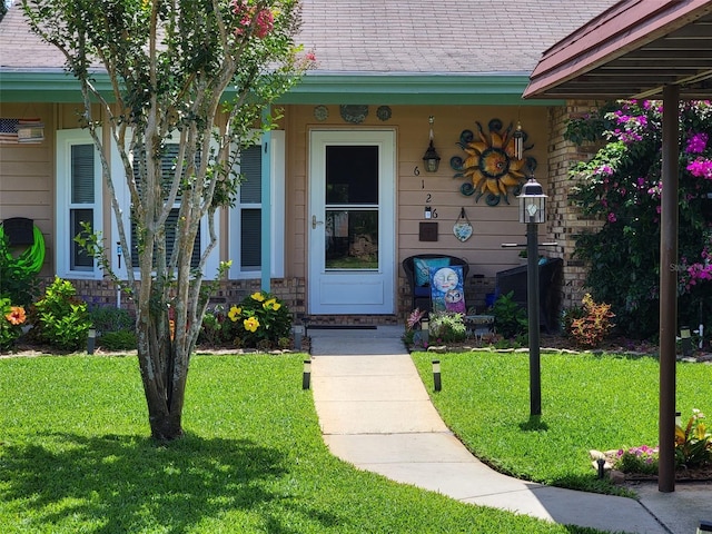 doorway to property featuring a yard