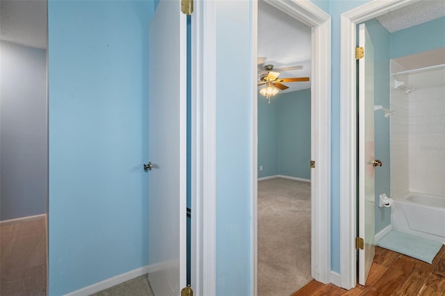 hall featuring hardwood / wood-style floors and a textured ceiling