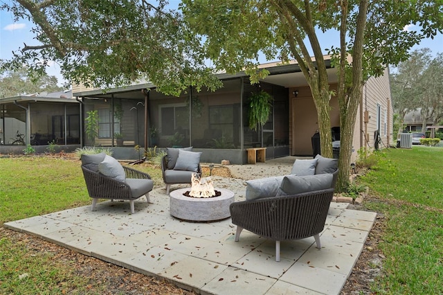 view of patio featuring a sunroom and an outdoor living space with a fire pit