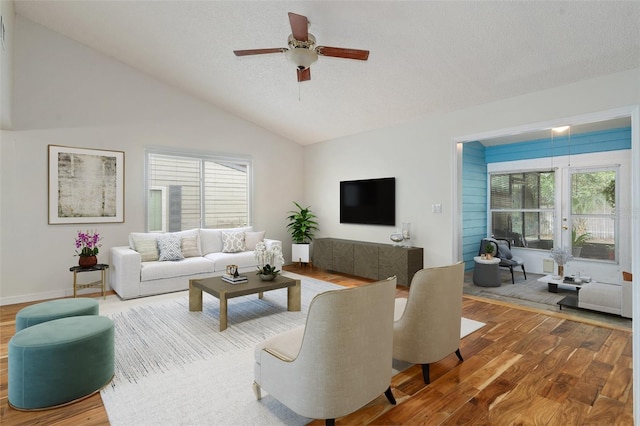 living room with hardwood / wood-style floors, plenty of natural light, ceiling fan, and lofted ceiling