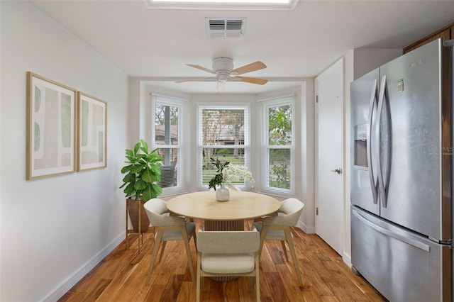 dining space featuring ceiling fan and light wood-type flooring