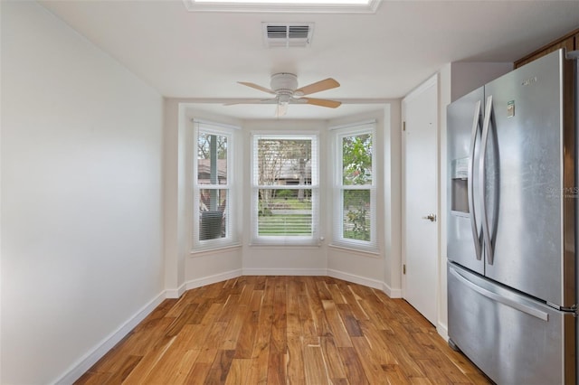 kitchen with stainless steel fridge with ice dispenser, light wood-type flooring, and ceiling fan