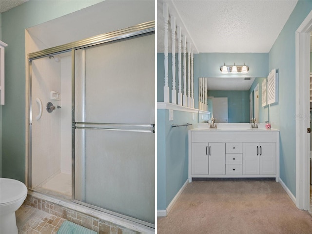 bathroom featuring vanity, a textured ceiling, toilet, and an enclosed shower