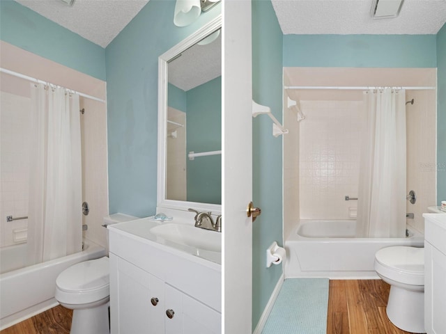 full bathroom featuring hardwood / wood-style flooring, toilet, and a textured ceiling