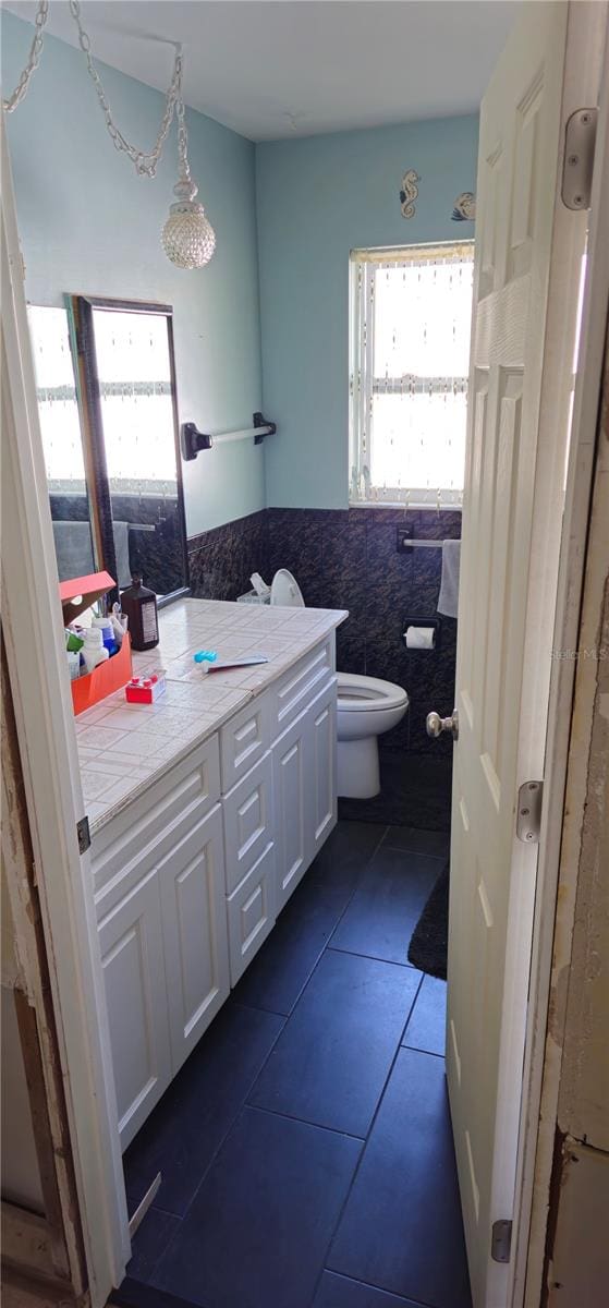 bathroom with vanity, tile patterned floors, and toilet