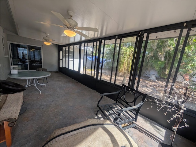 sunroom featuring ceiling fan