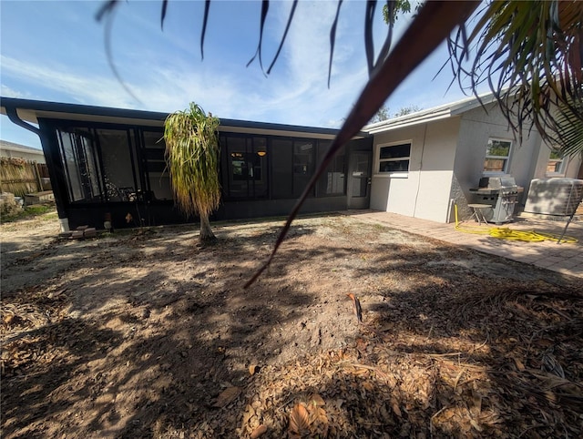 rear view of house featuring a sunroom