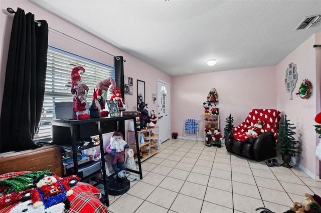 3336 W Heiter St, Tampa, FL 33607 - sitting room featuring light tile patterned floors, a textured ceiling, and baseboards