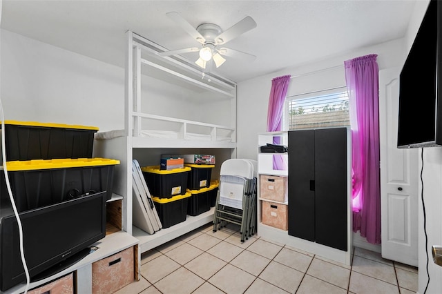 bedroom with ceiling fan and light tile patterned floors