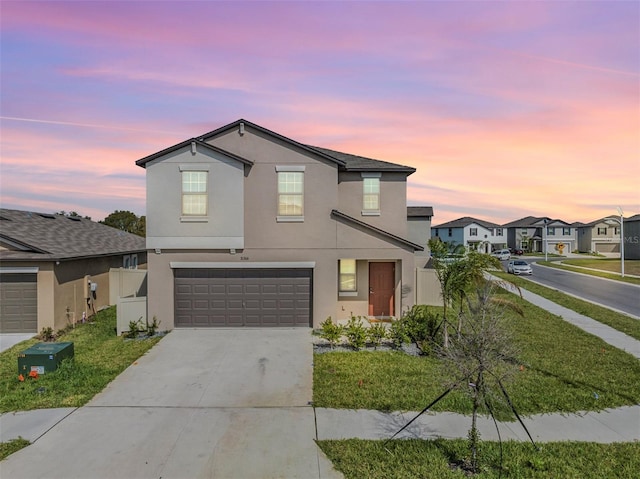 view of property featuring a yard and a garage