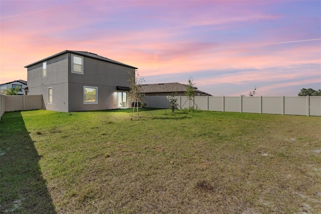 view of yard at dusk