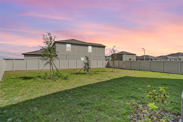 view of yard at dusk