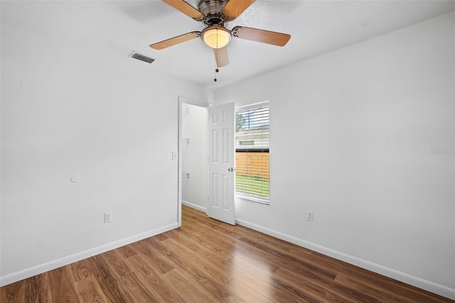 empty room with light wood-type flooring and ceiling fan