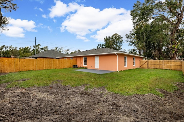 back of house featuring a patio, central AC, and a yard