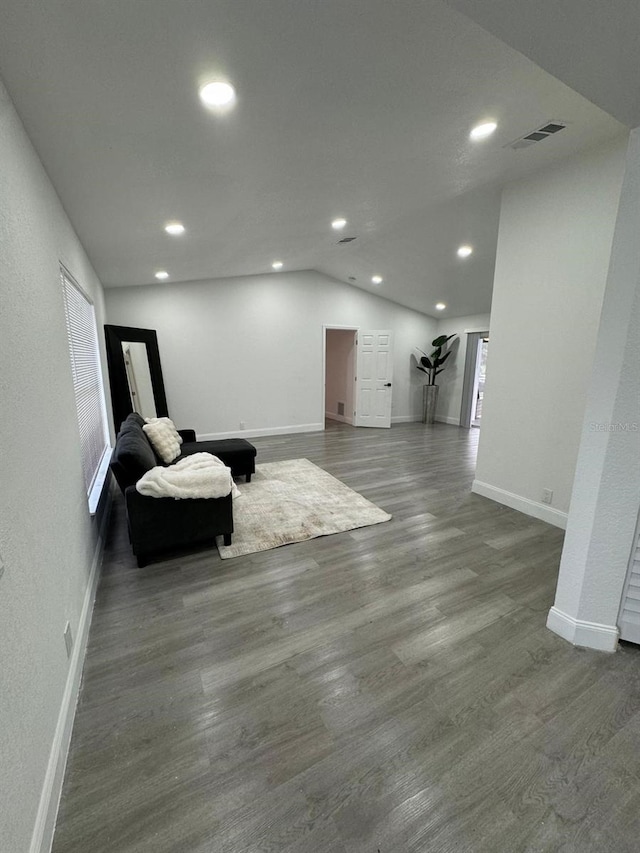 living area with lofted ceiling and dark hardwood / wood-style floors