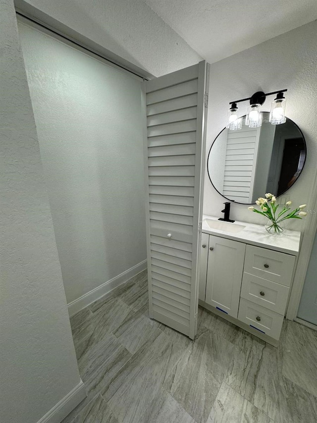 bathroom with vanity and a textured ceiling