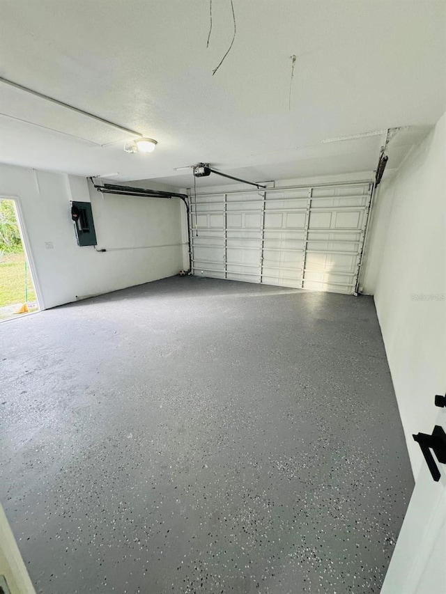 garage featuring a garage door opener and electric panel