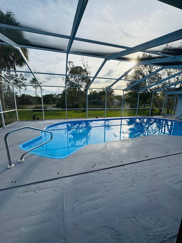 view of swimming pool with a lanai and a patio area