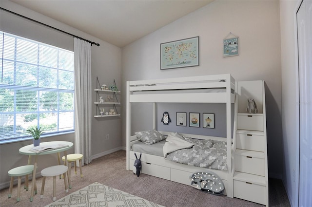 carpeted bedroom with lofted ceiling