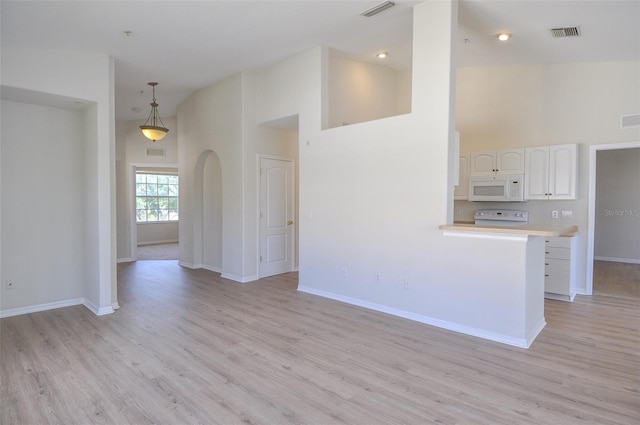 interior space featuring high vaulted ceiling and light wood-type flooring