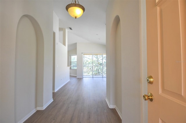 hall featuring hardwood / wood-style flooring and lofted ceiling