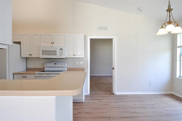 kitchen featuring white appliances, decorative light fixtures, a notable chandelier, light hardwood / wood-style floors, and white cabinetry