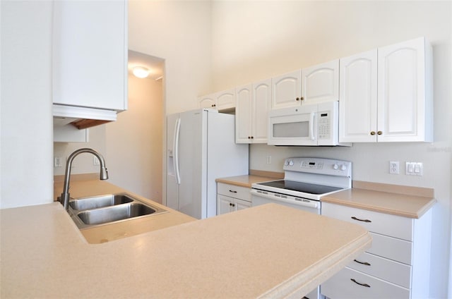 kitchen featuring white appliances, white cabinets, and sink