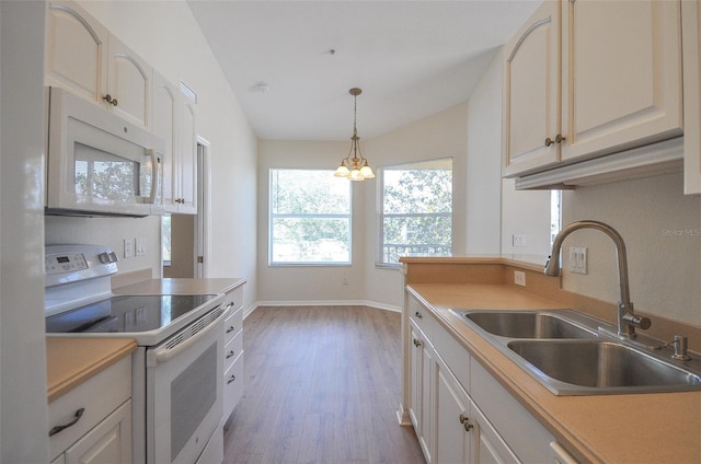 kitchen with sink, hanging light fixtures, light hardwood / wood-style flooring, lofted ceiling, and white appliances