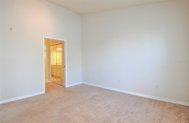 spare room featuring light colored carpet