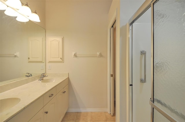 bathroom with vanity, tile patterned floors, and a shower with door