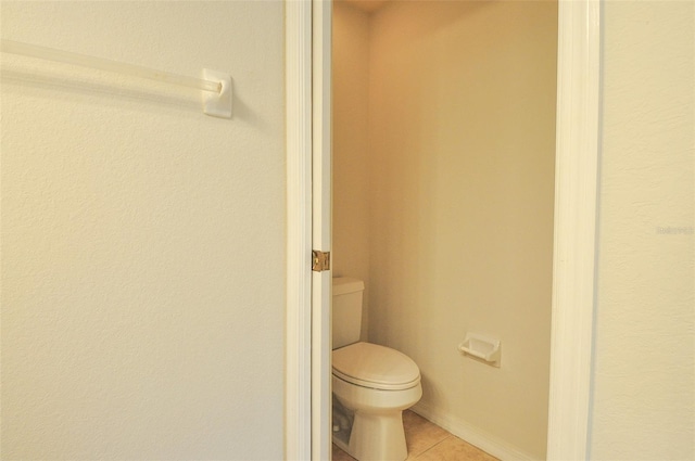 bathroom featuring toilet and tile patterned flooring