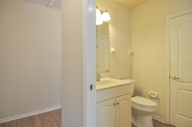 bathroom with vanity, toilet, and wood-type flooring