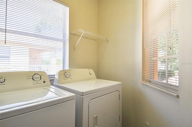 clothes washing area featuring washer and clothes dryer