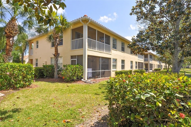 rear view of property featuring a lawn