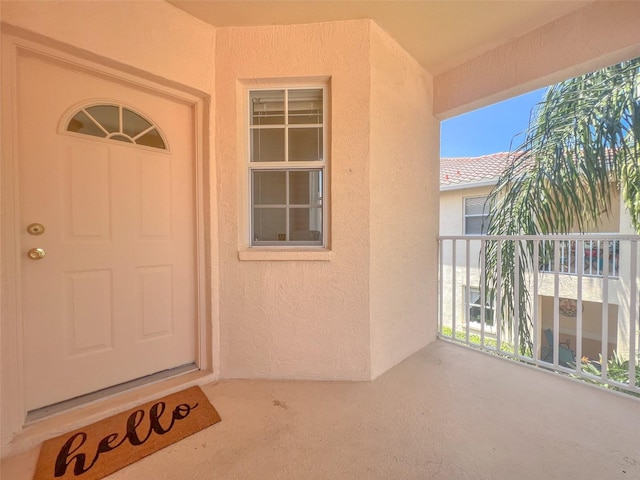 property entrance with a balcony