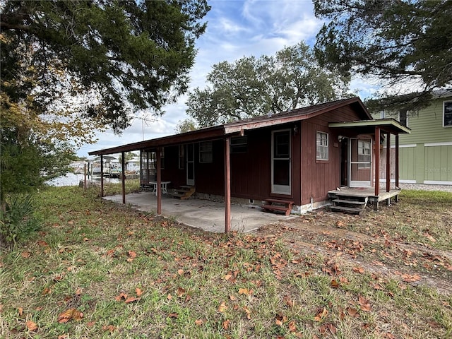 rear view of house featuring a yard and a patio area