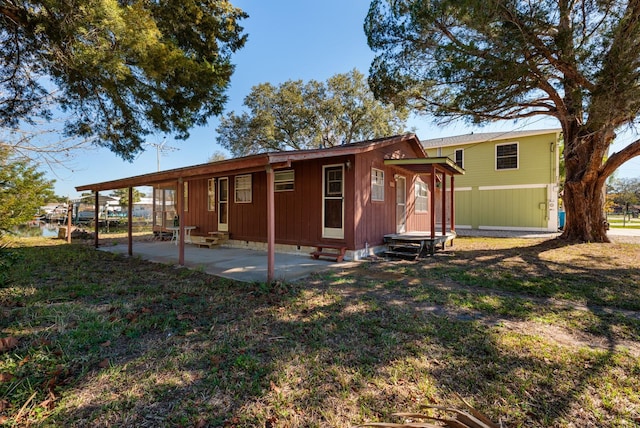 back of house featuring a yard and a patio area