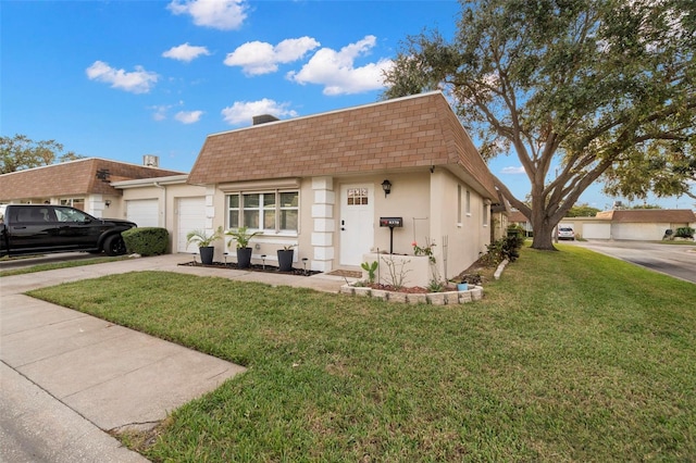 view of front of home featuring a garage and a front lawn