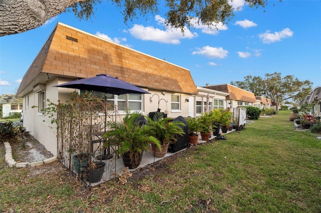 rear view of property with a yard