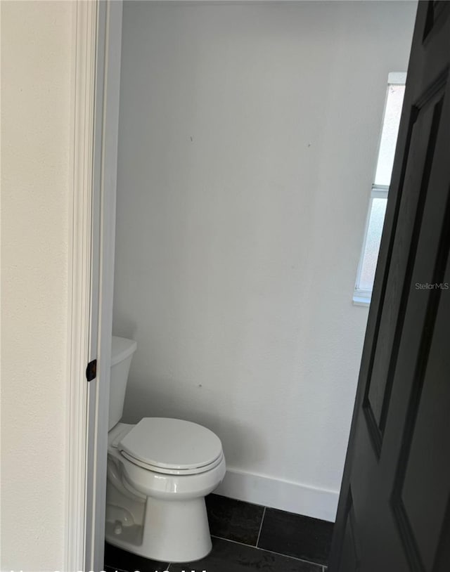 bathroom featuring tile patterned flooring and toilet