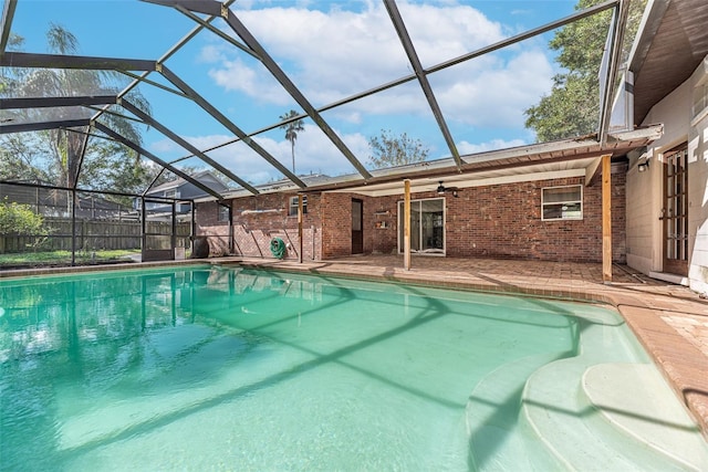 view of pool featuring ceiling fan, a lanai, and a patio