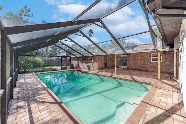 view of swimming pool with a patio area and glass enclosure