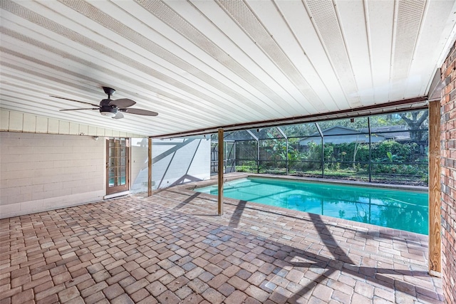 view of pool featuring a patio, ceiling fan, and glass enclosure