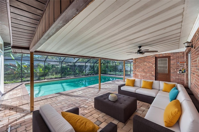 view of pool with a lanai, outdoor lounge area, a patio, and ceiling fan