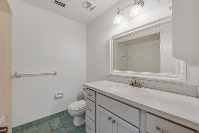 bathroom featuring tile patterned flooring, vanity, a textured ceiling, and toilet