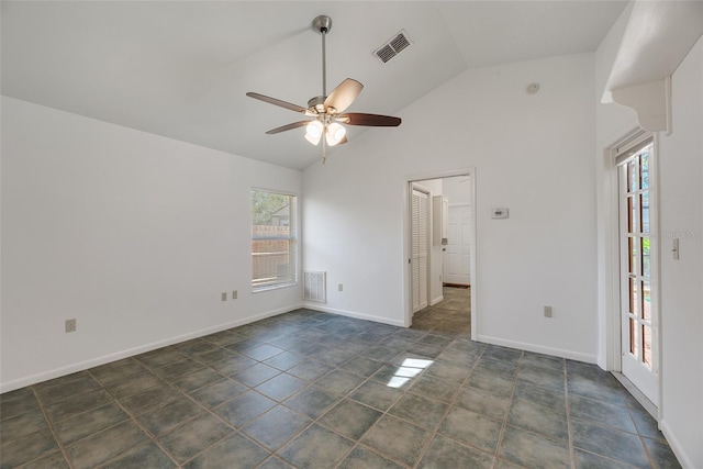 spare room featuring lofted ceiling, a healthy amount of sunlight, and ceiling fan