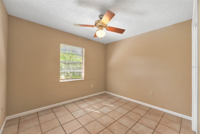 tiled empty room featuring a textured ceiling and ceiling fan