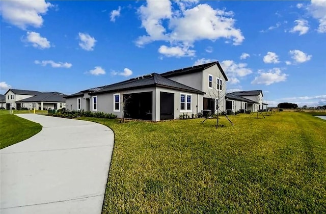 view of side of home featuring a sunroom and a yard