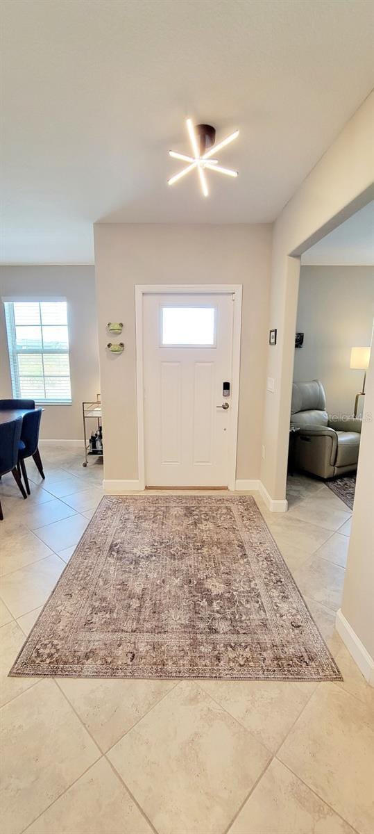 foyer entrance featuring light tile patterned flooring