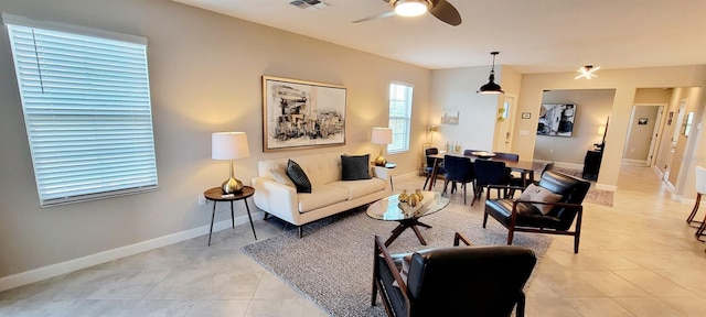 tiled living room featuring ceiling fan